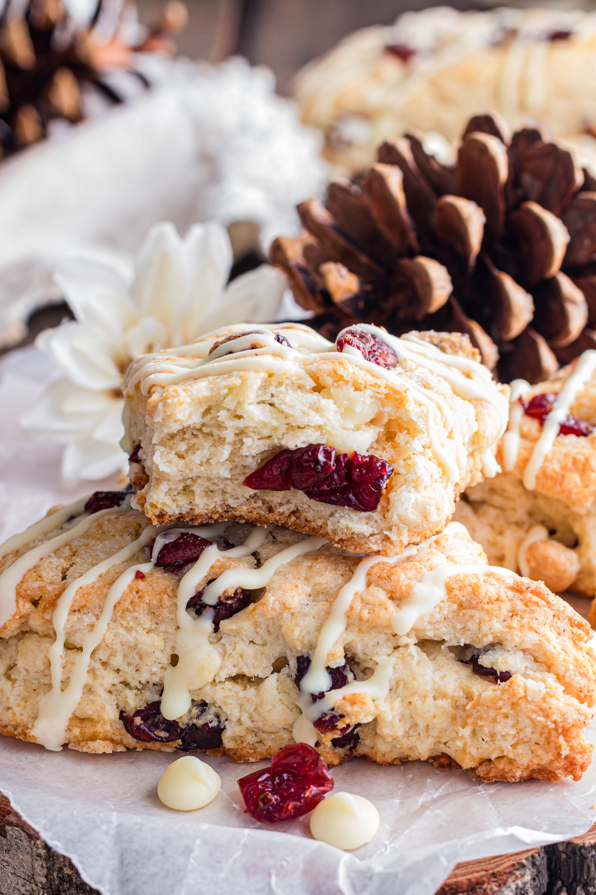 Cranberry scones stacked on wood platter.