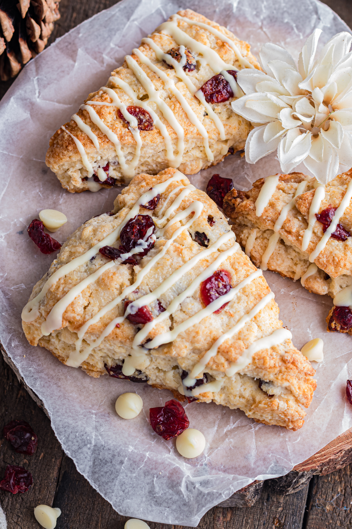 Cranberry white chocolate scones on wood table.