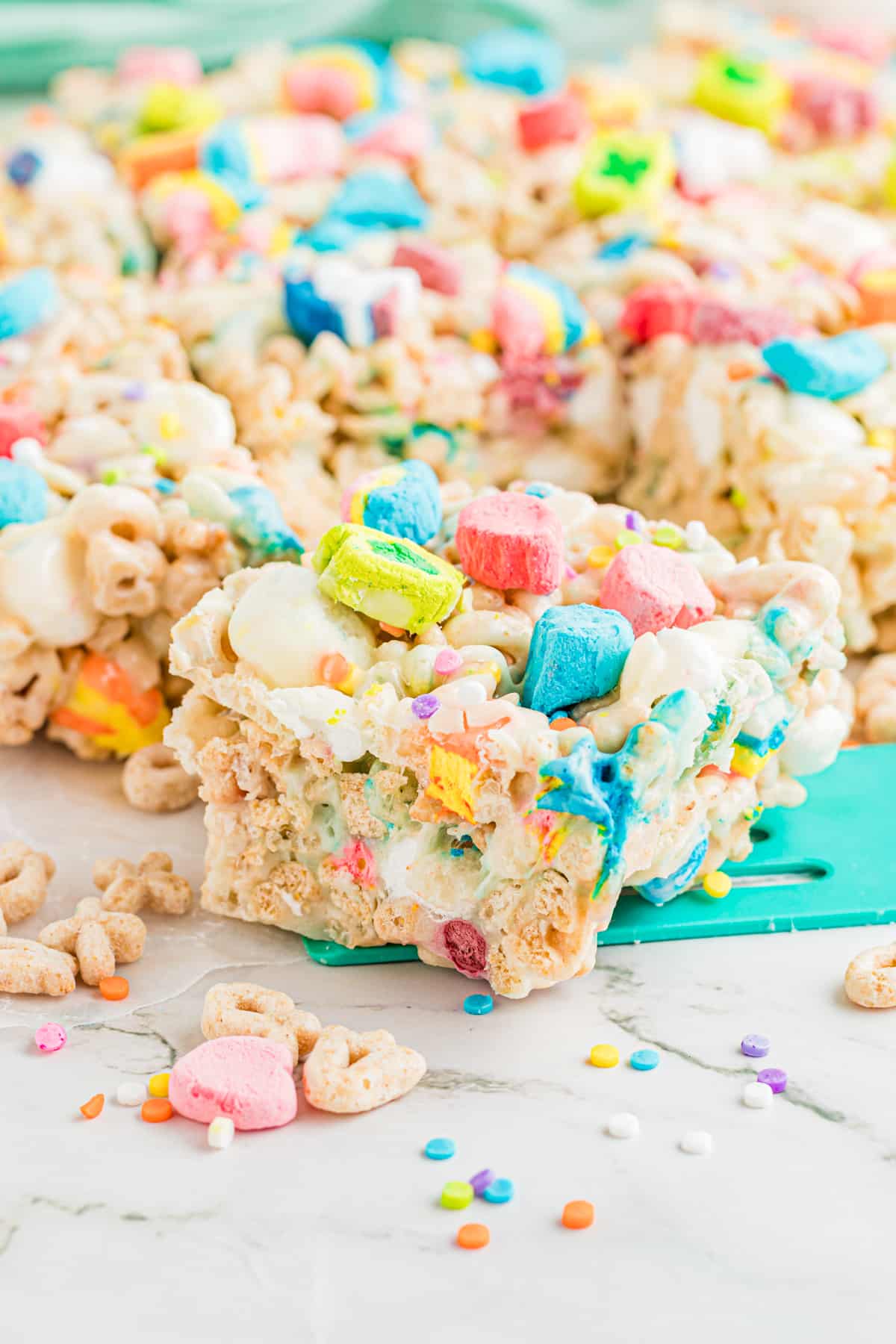 Lucky Charms Rice Krispie Treat on a blue spatula.
