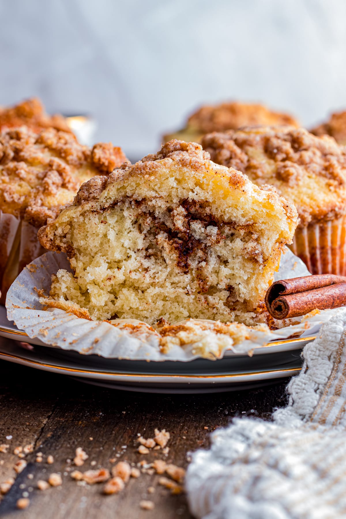 Cinnamon streusel muffin cut open with swirl inside.