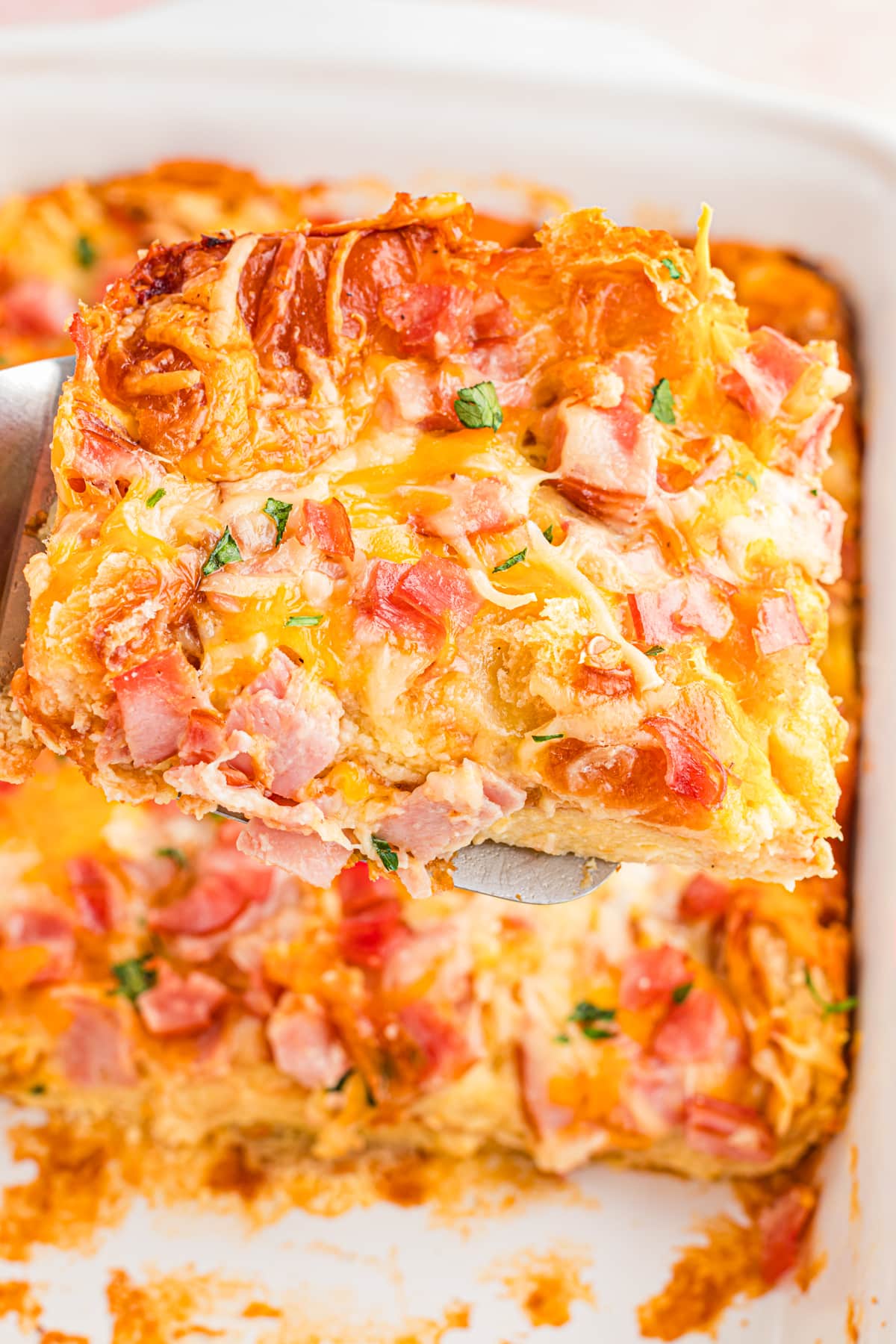 Ham and Cheese Breakfast Casserole on spatula being ready to serve.